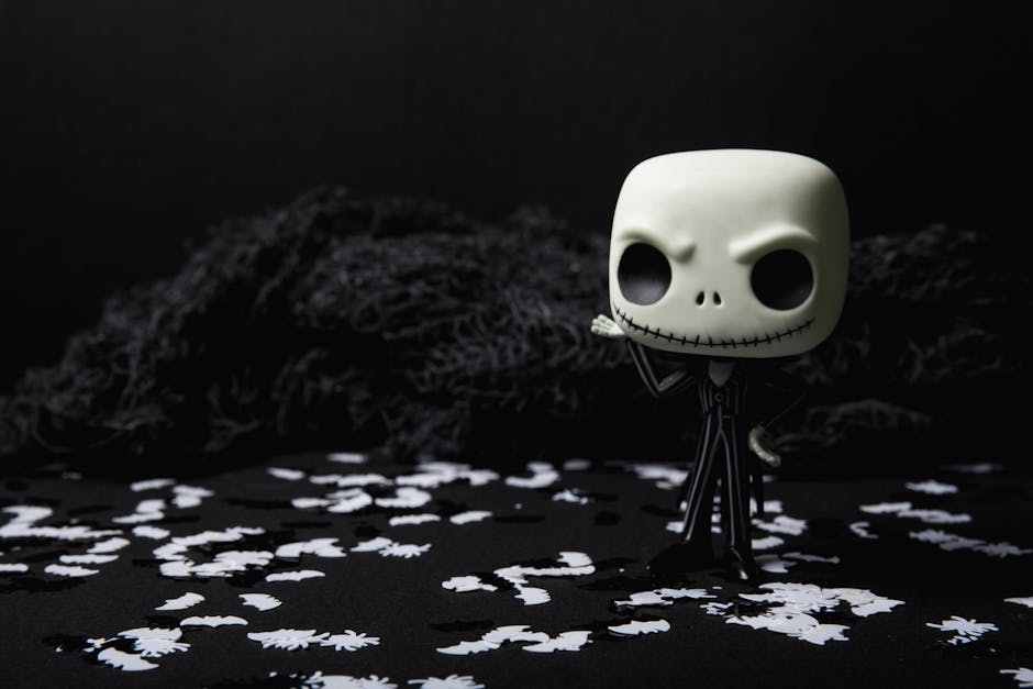 A creepy toy figure on a dark background adorned with eerie white shapes, ideal for Halloween themes.