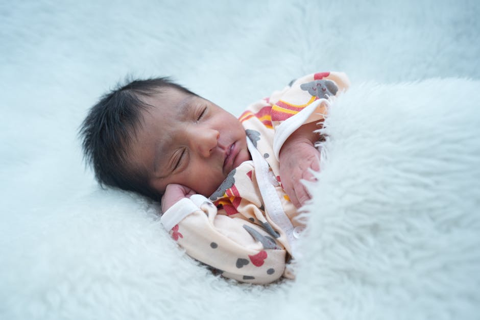 Peaceful sleeping infant in soft, warm lighting representing new beginnings